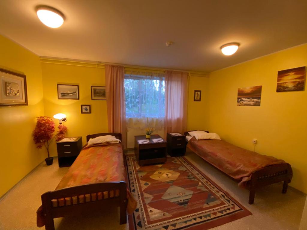 Postel nebo postele na pokoji v ubytování Torgu Royal Guesthouse