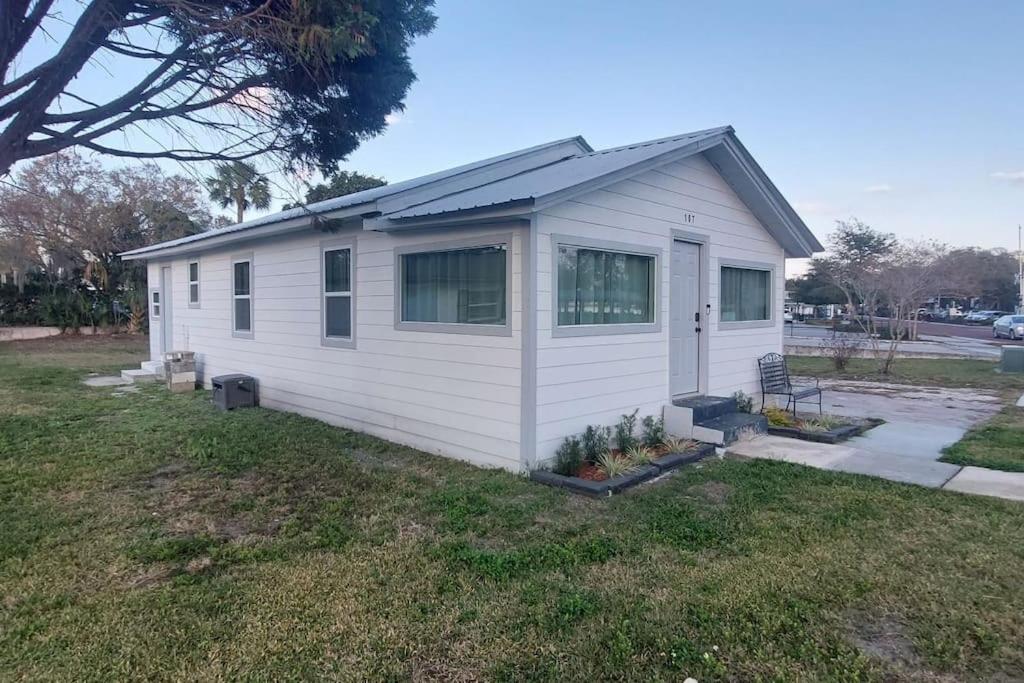 a small white house in a yard at Bungalow overlooking Lake Dora! in Tavares