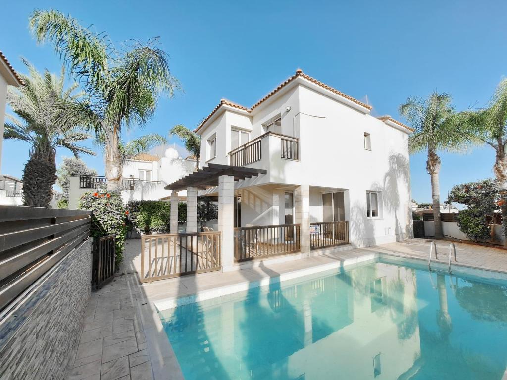 a large white house with a swimming pool in front of it at Villa Lynn Chill Out Seaview in Ayia Napa