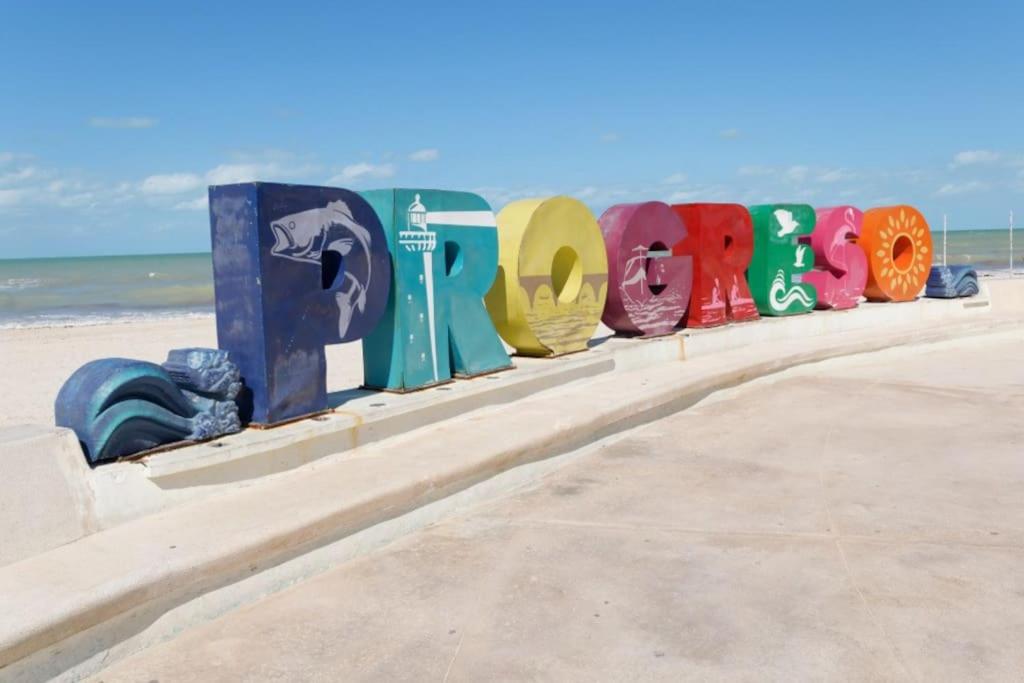 a row of colorful signs on the beach at An amazing stay in Progreso, close to everything in Progreso