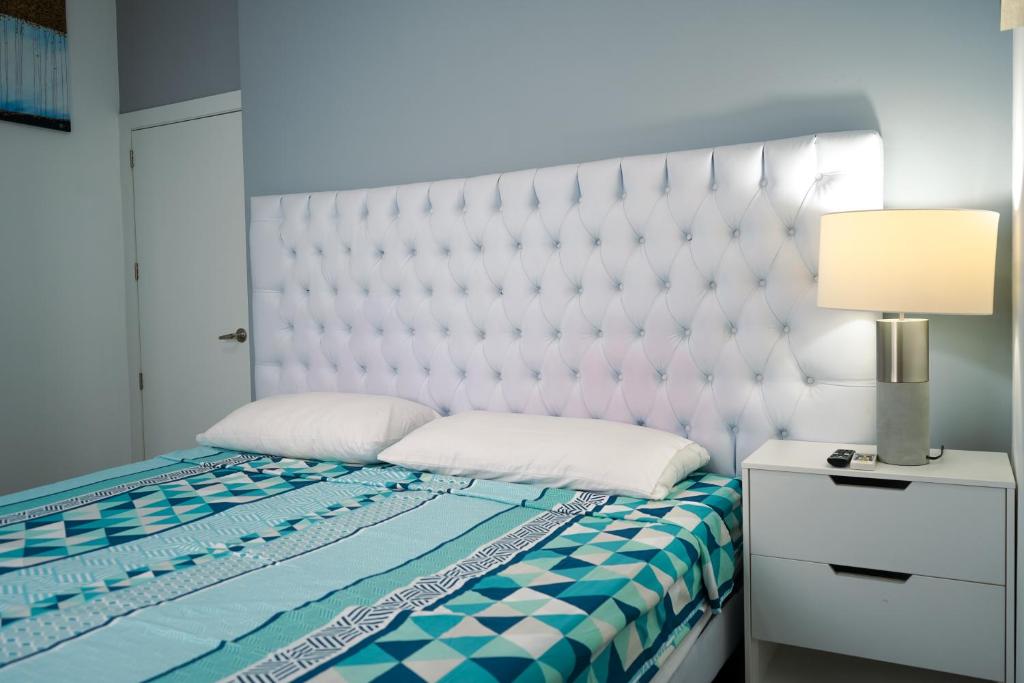 a bedroom with a bed with a white headboard and a lamp at Casa Llanos de Costa y Mar in San Clemente