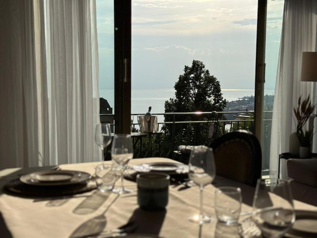 a table with a white table cloth and wine glasses at Villa Montreux in Montreux