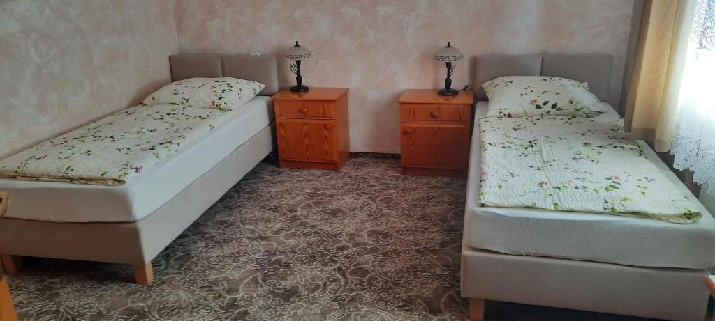 a bedroom with two beds and two night stands at Apartament Barbara in Ruda Śląska