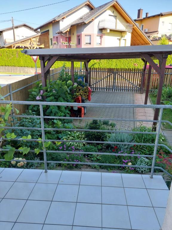 a vegetable garden with a wooden pergola at Apartma Kaj in Kaja in Maribor