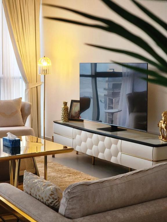 a living room with a large fish tank on the wall at ROYAL APARTMENTS DUBAI in Dubai