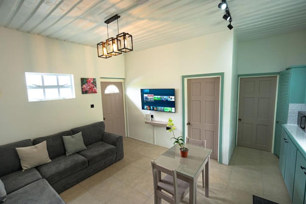 a living room with a couch and a table at SOHI Villa in Gros Islet