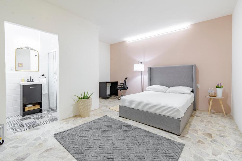 a white bedroom with a bed and a fireplace at Casa Marina Habitacion Seattle in Acámbaro