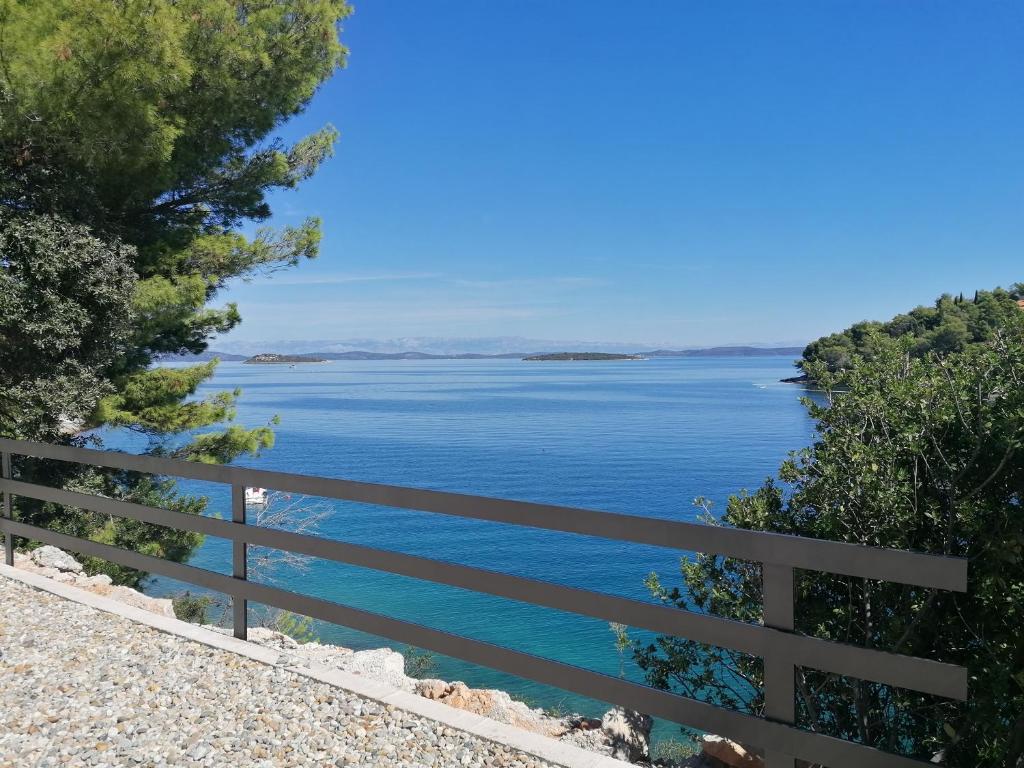 a view of a lake from a fence at Bella Luxury Apartment in Sali