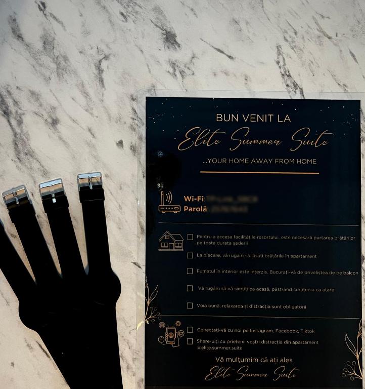 a black glove sitting on a counter next to a diploma at Elite Summer Suite in Năvodari