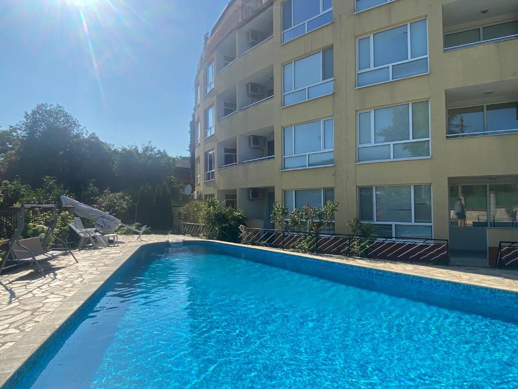 a swimming pool in front of a building at Studios in Complex Colosseum in Kranevo