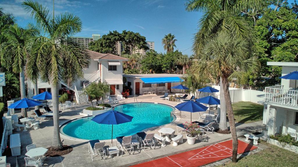 an overhead view of a pool with blue umbrellas at Gulfside Resort Unit 2 in St. Pete Beach