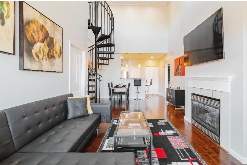 a living room with a couch and a fireplace at Downtown Shared Apartment in Providence