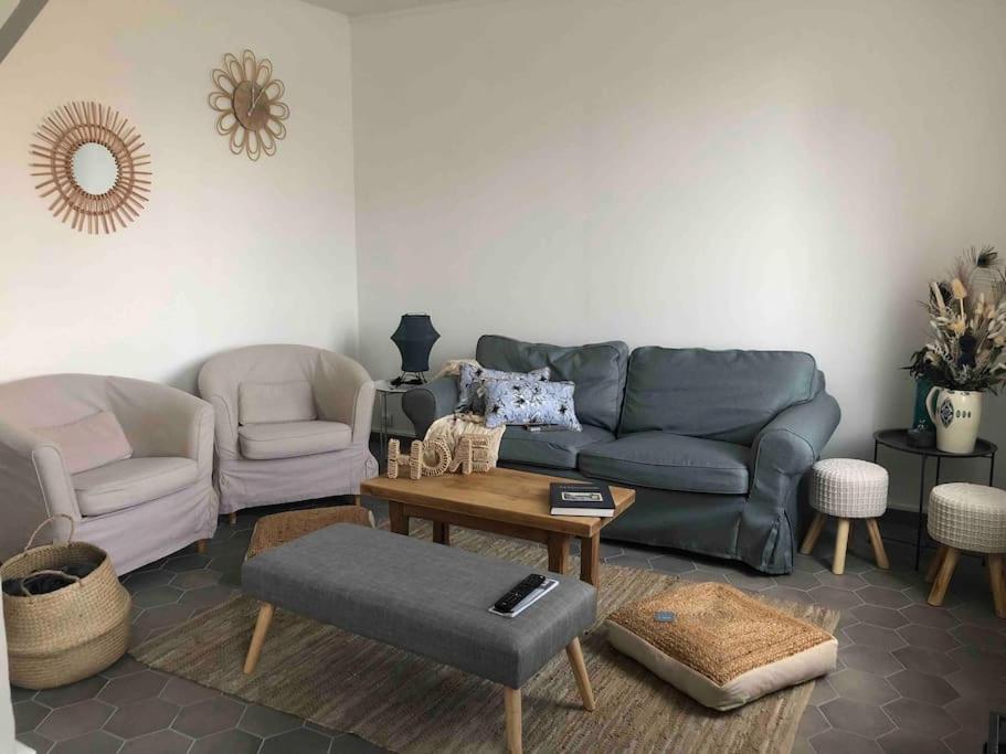 una sala de estar con un sofá y dos sillas en La briqueterie de Maromme, en Maromme