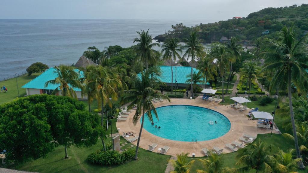 an aerial view of a resort with a swimming pool and the ocean at Atami Escape Resort in La Libertad