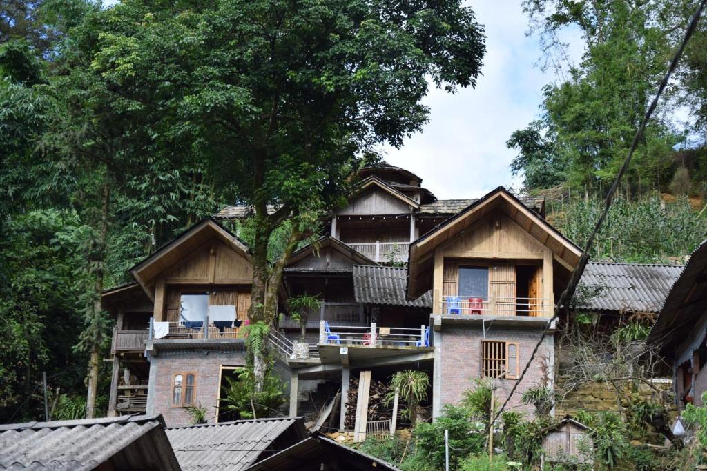 a house on the side of a hill with trees at Mama Gia Homestay in Sa Pa
