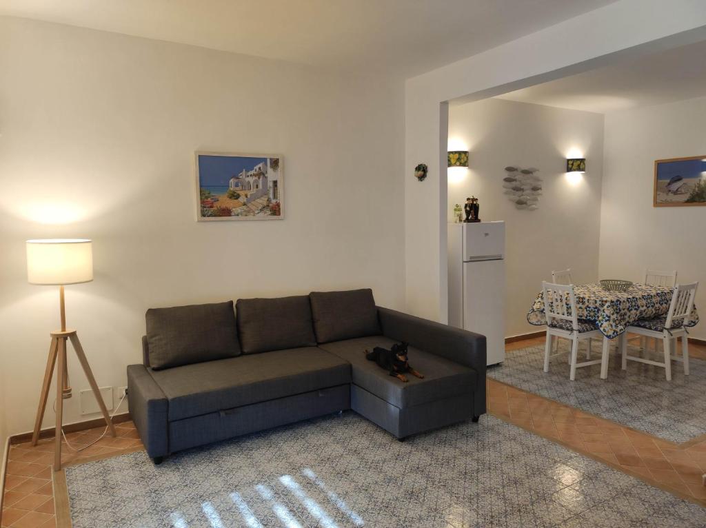a living room with a couch and a table at Casa Porto Palo in Porto Palo