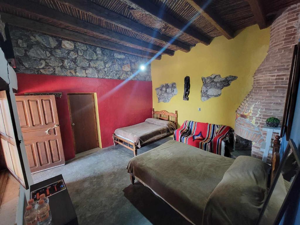 Postel nebo postele na pokoji v ubytování HOTEL RINCÓN MAGICO REAL DE CATORCE