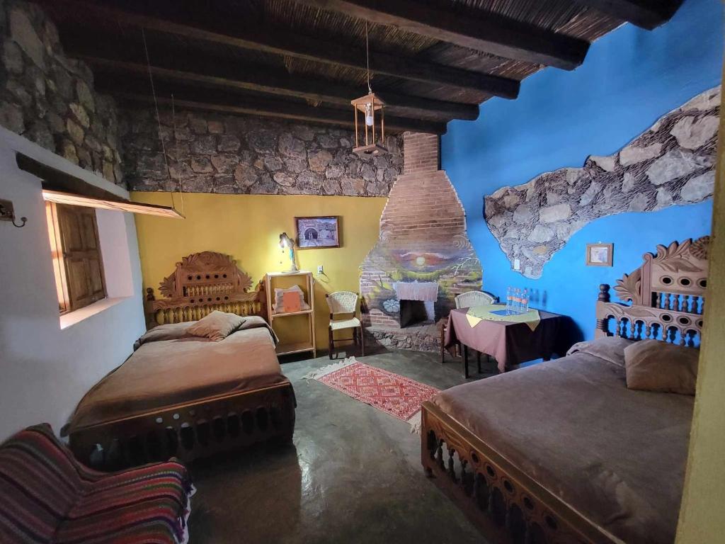 Postel nebo postele na pokoji v ubytování HOTEL RINCÓN MAGICO REAL DE CATORCE