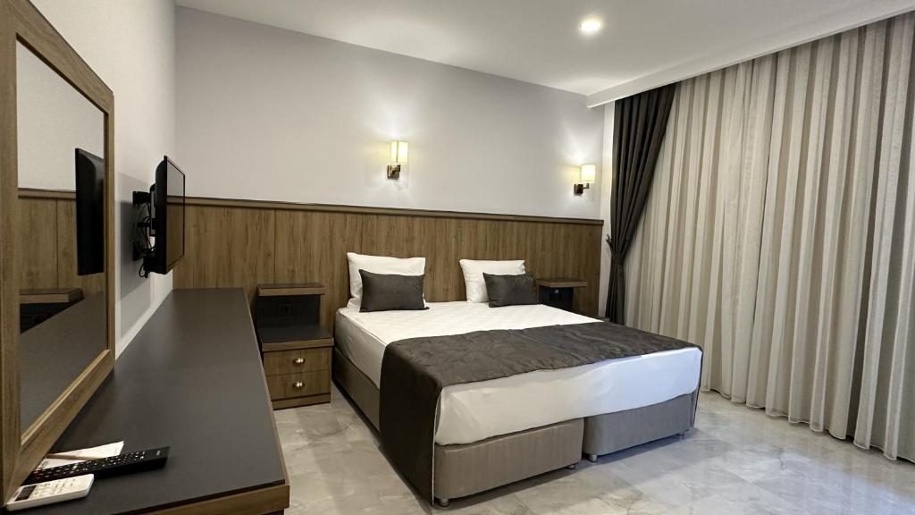 Postel nebo postele na pokoji v ubytování Quality Gold Suite Hotel