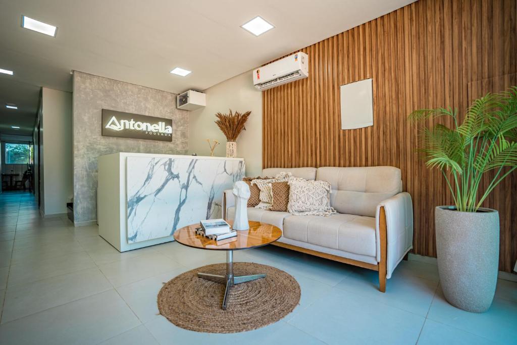 a living room with a couch and a table at Pousada Antonella in Maragogi