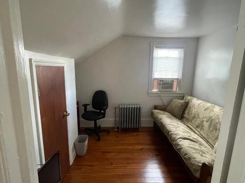 a living room with a couch and a chair at A comfortable home for you in Trenton