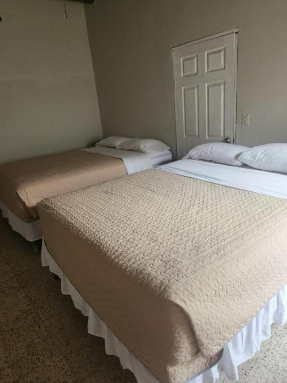 Postel nebo postele na pokoji v ubytování Aparta Hotel Palmerola