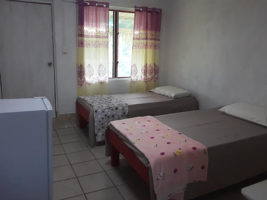 Postel nebo postele na pokoji v ubytování Kathy B Guesthouse