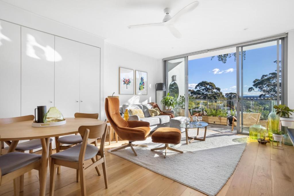 a living room with a table and chairs at FINL503LC - Finlayson Heights in Sydney