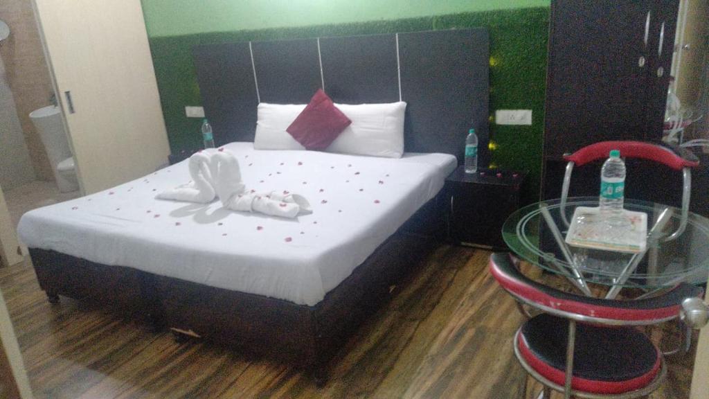 a bedroom with a bed and a glass table at The Palm Tree -Family Stay in Amritsar