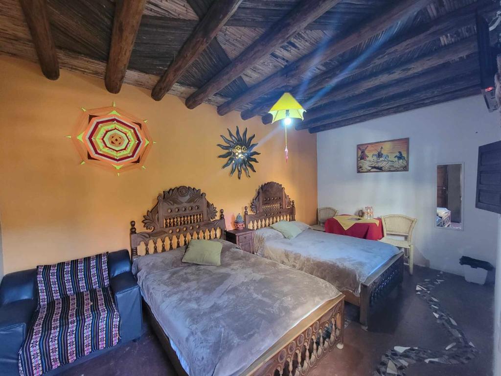 Postel nebo postele na pokoji v ubytování HOTEL RINCÓN MAGICO REAL DE CATORCE