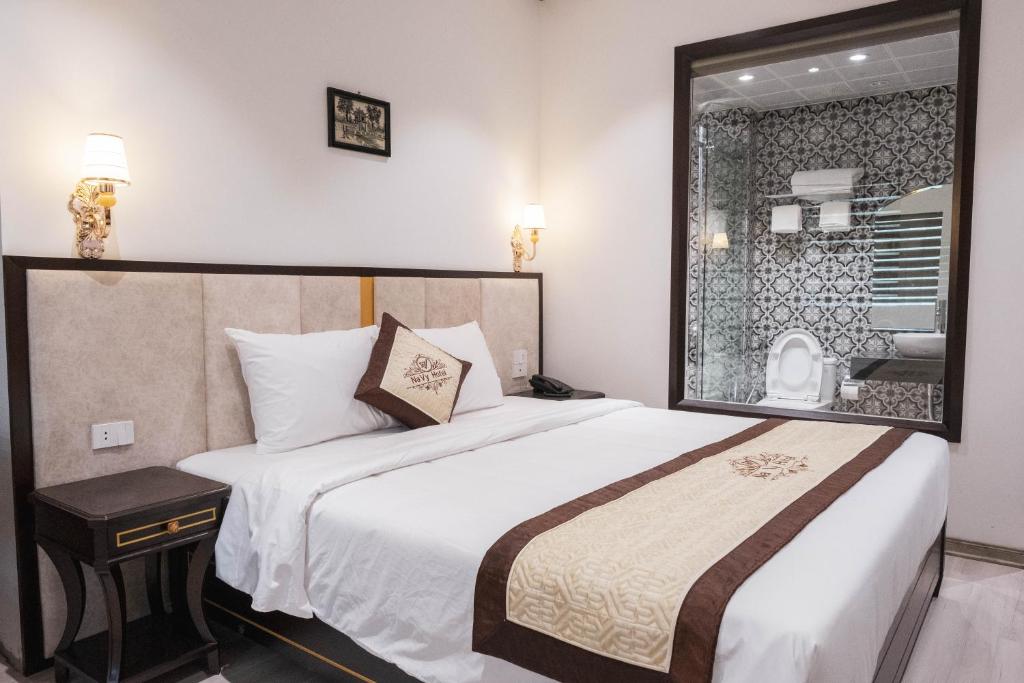 Postel nebo postele na pokoji v ubytování Navy Hotel Hà Nội