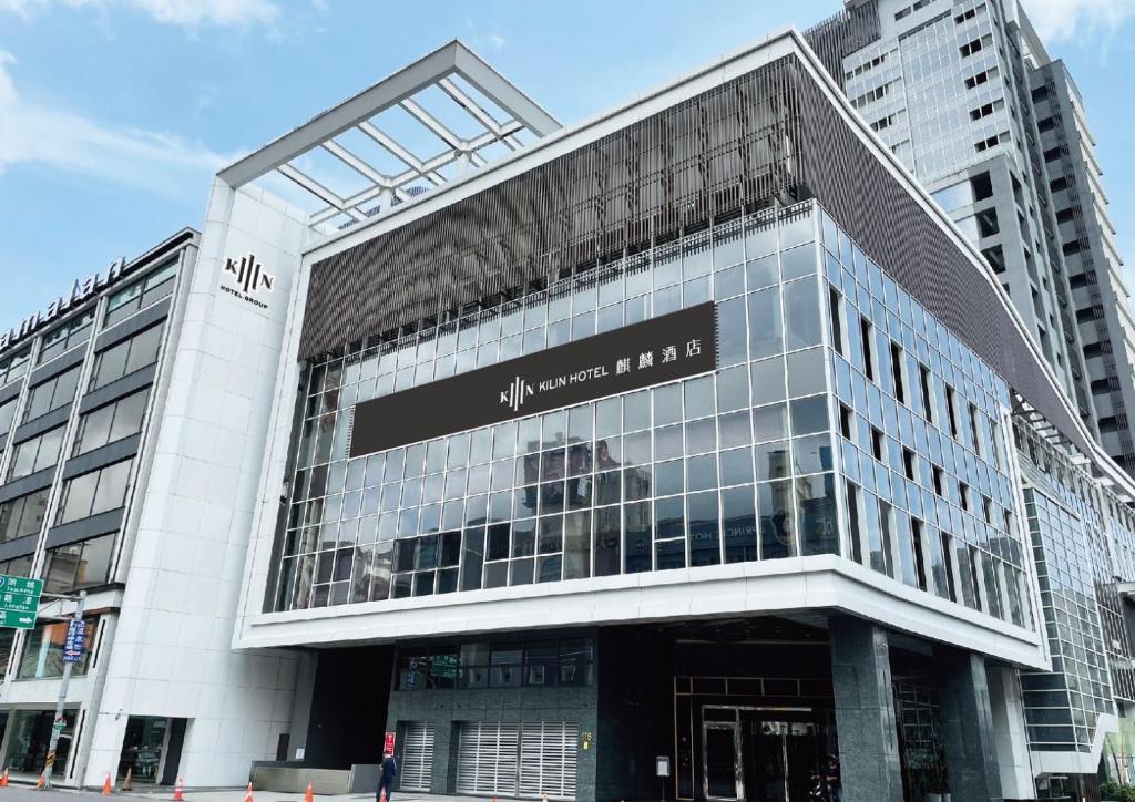 a large building with a sign on the front of it at Kilin Hotel, JiaoXi in Jiaoxi