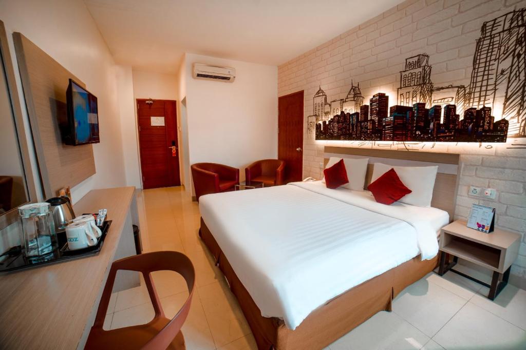 Postel nebo postele na pokoji v ubytování Zoom Hotel Mulawarman