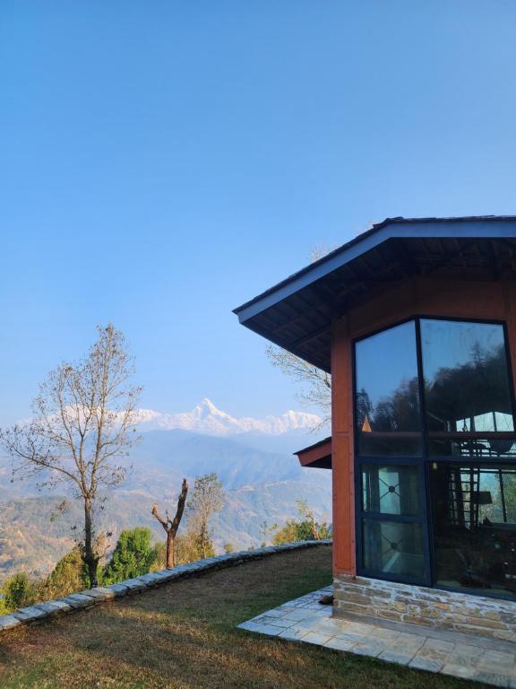 a house with a view of the mountains at Deumadi Mountain Cottage in Pokhara