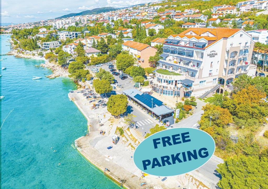 an aerial view of a resort with the text free parking at Hotel Marina in Selce