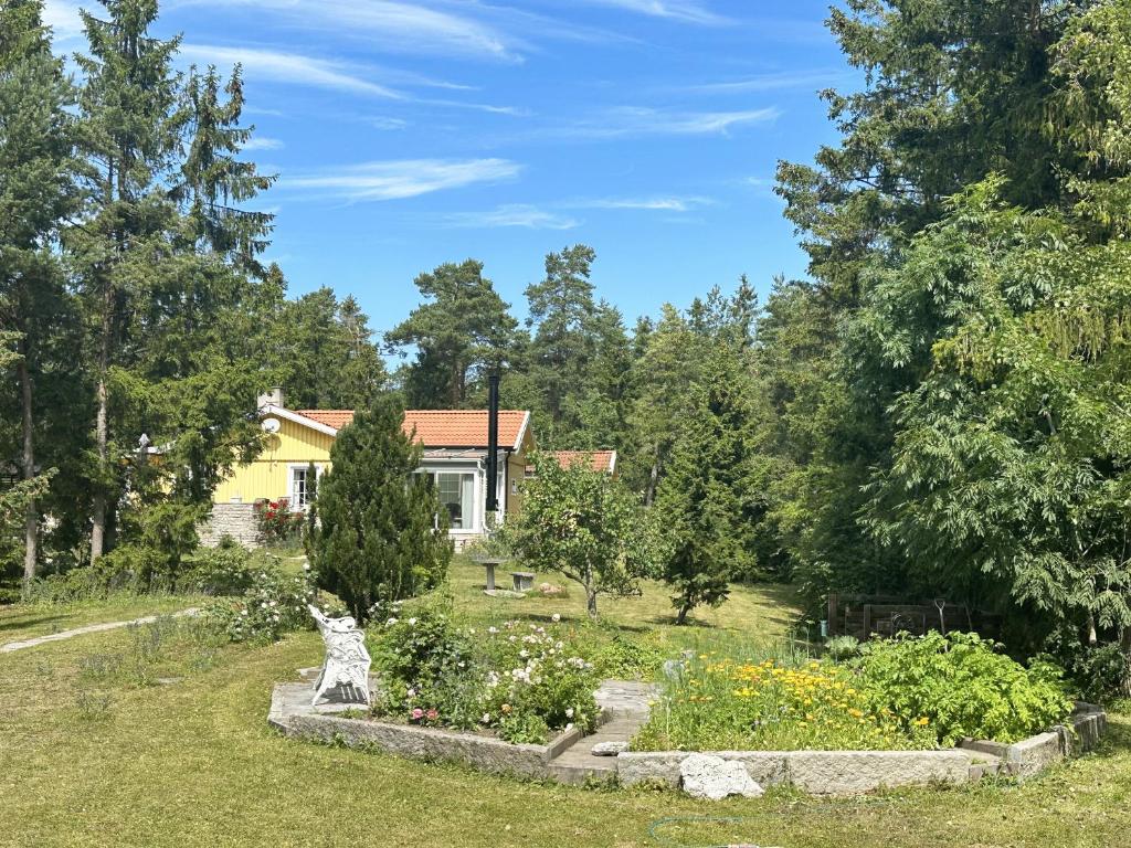 a house with a garden in front of it at Cozy cottage on Gotland with sauna near salty baths in Lärbro