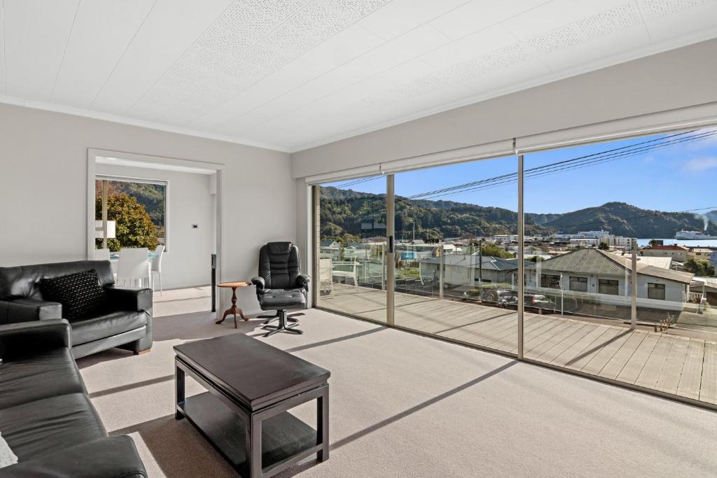 an empty living room with a large glass window at Seaside Sounds - Picton Upstairs Unit in Picton