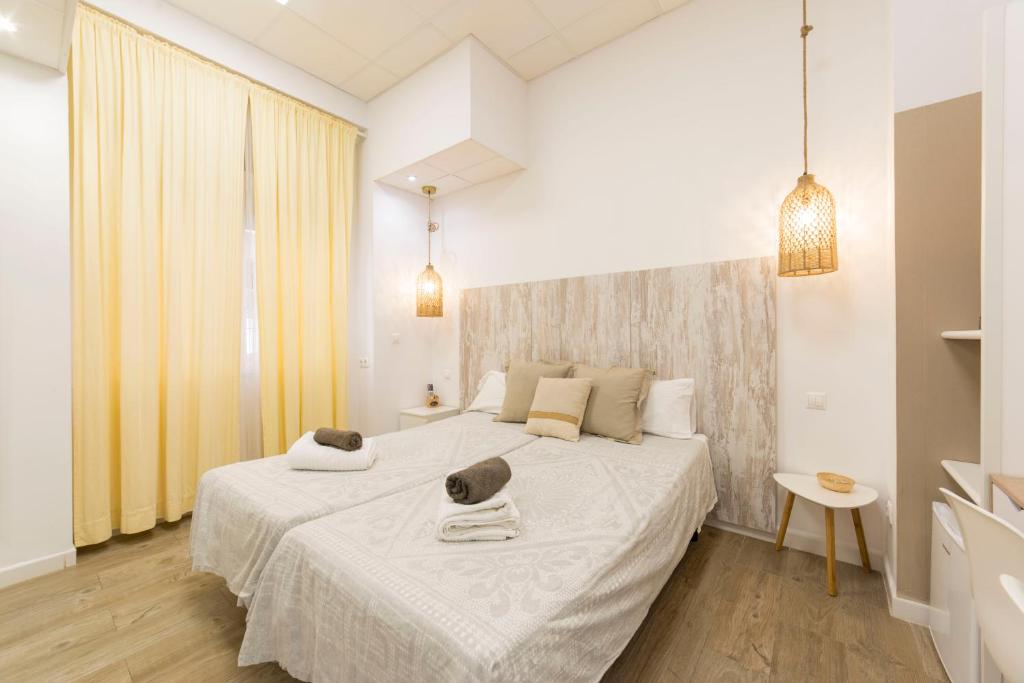 a bedroom with a large white bed in a room at Home up Qurtuba in Córdoba