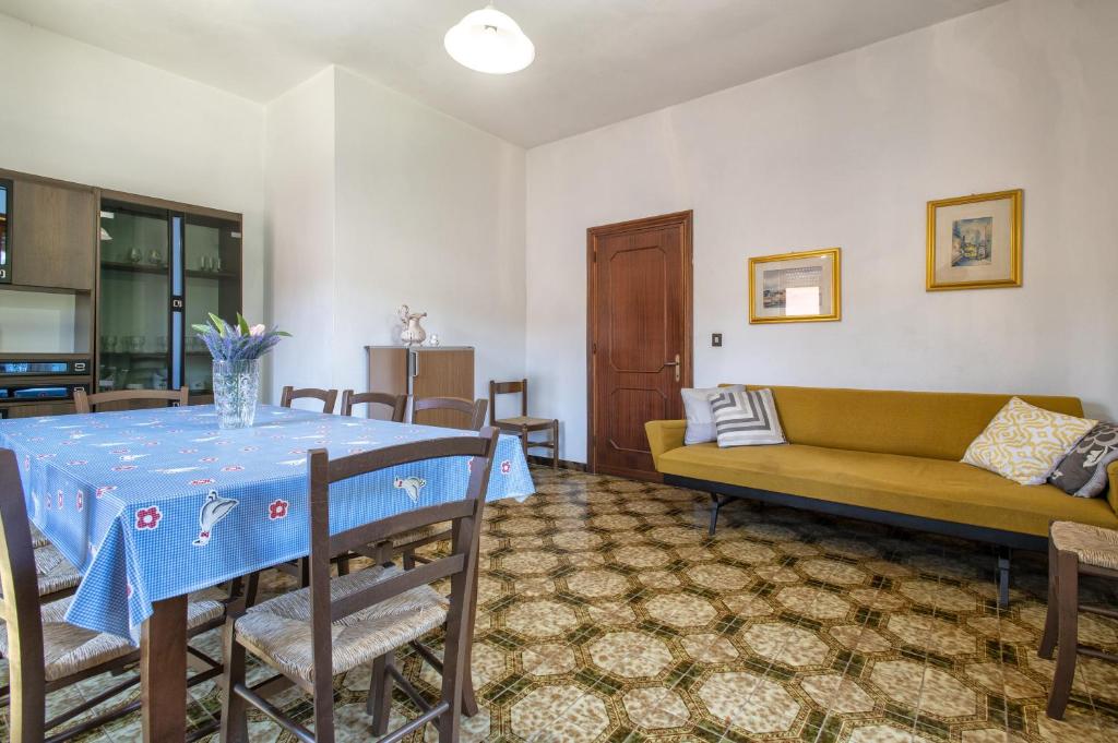 salon ze stołem i kanapą w obiekcie Spacious home in Costa Rossa w mieście Trinità dʼAgultu
