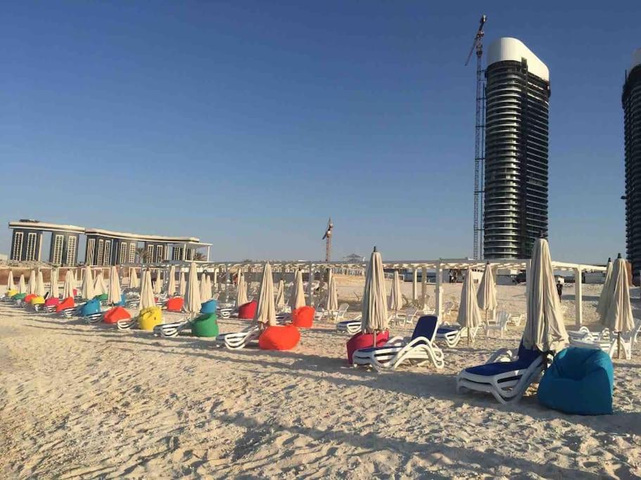 a row of chairs and umbrellas on a beach at Porto Golf Marina Alamein in El Alamein