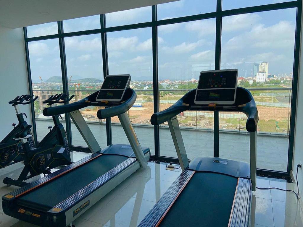 two exercise bikes in a gym with a window at HAPPY HOUSE PREMIER APARTMENT - Căn hộ cao cấp 3 phòng ngủ tại Huế in Hue