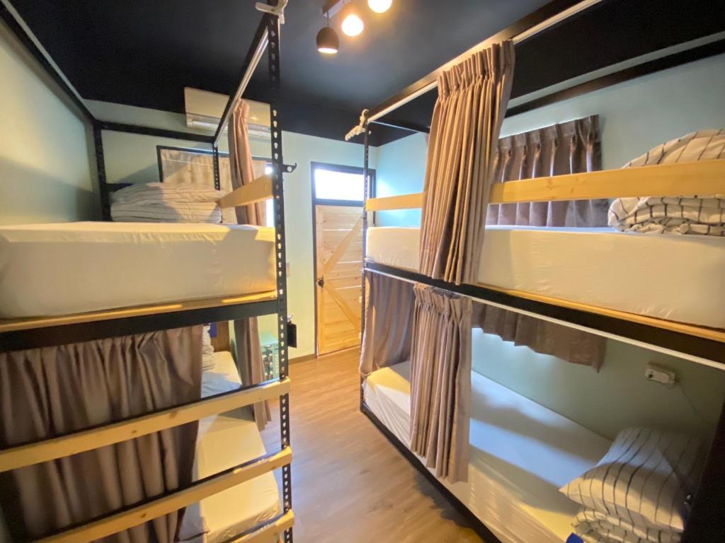 a room with several bunk beds in it at HeMei Homestay in Ho-mei