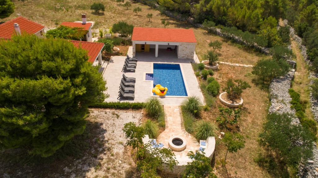 an aerial view of a house with a swimming pool at Luxury Villa Nature with heated private pool, sauna & fire pit, a short walk to the beach in Milna