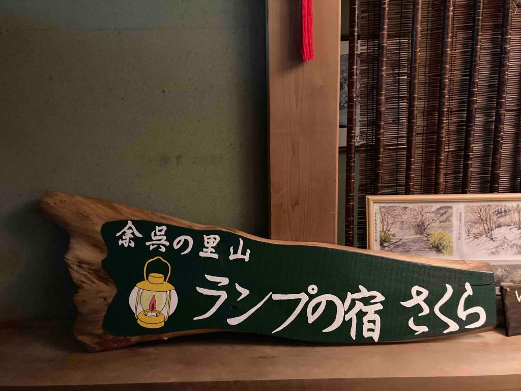 a green pillow with asian writing on it at 余呉の里山-ランプの宿-さくら in Nagahama