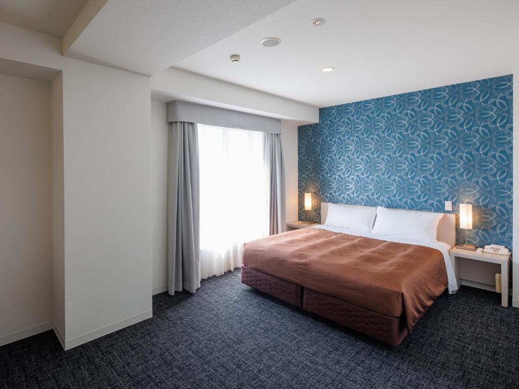 Postel nebo postele na pokoji v ubytování J Hotel Rinku