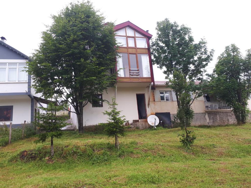 a house on a hill with trees in front of it at Abdullah Su in Akcaabat