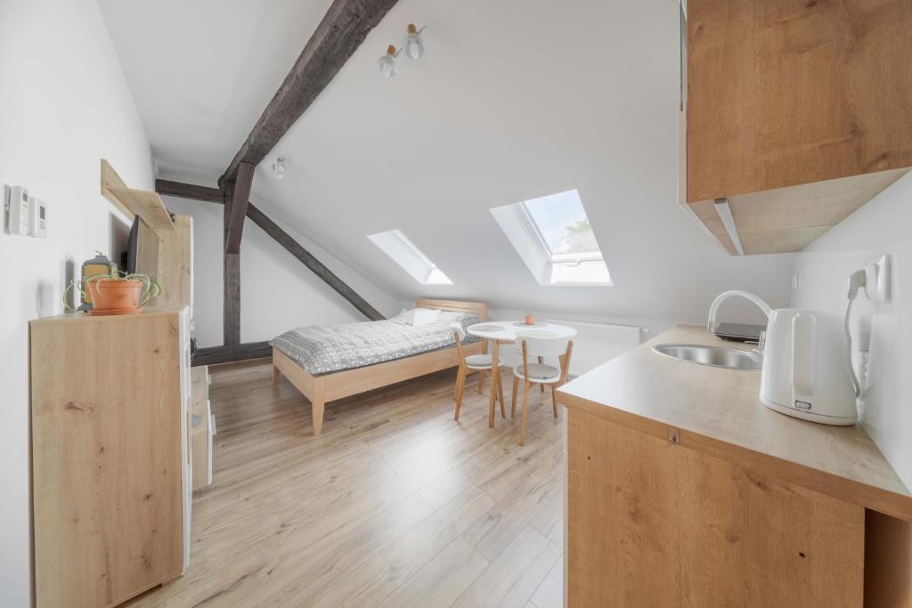 a kitchen and living room with a bed in a loft at GUDU apartments in Košice