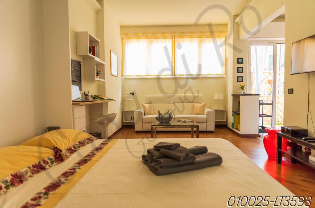 a living room with a bed and a living room with a couch at Casa di Ro - New Foce in Genoa