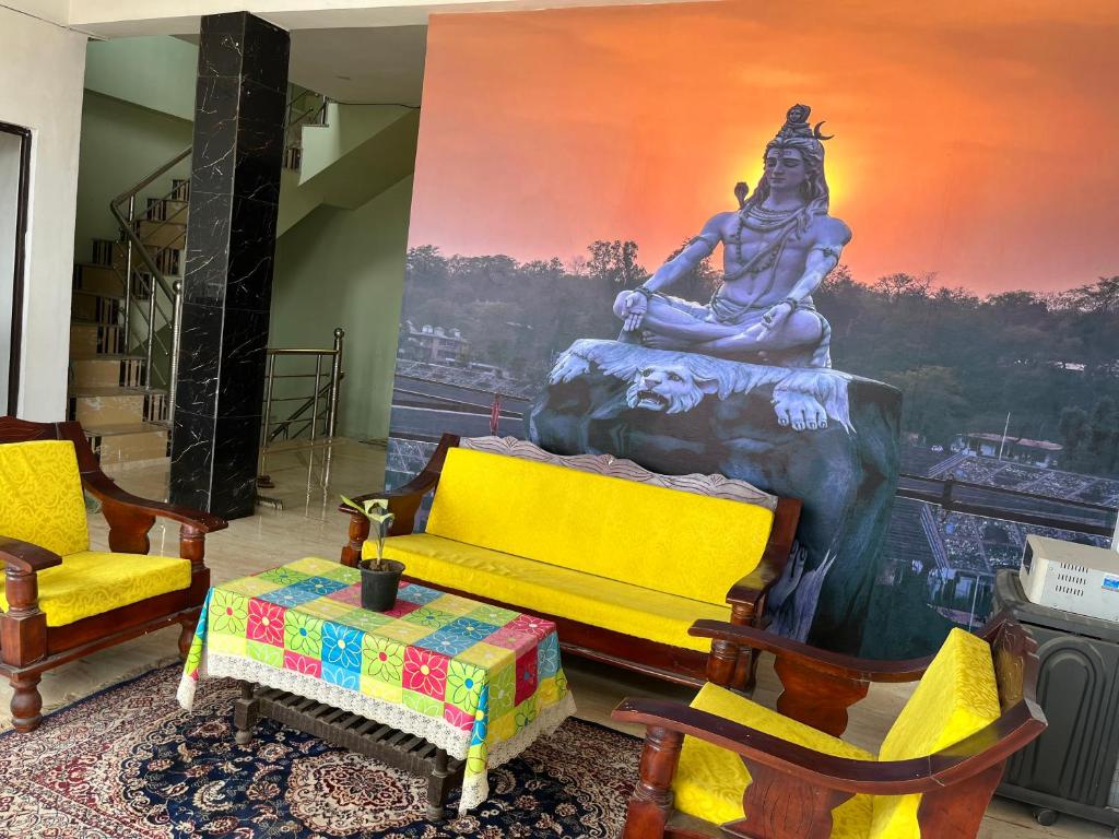 a living room with a large painting of a statue at Prabhu Sadan home stay in Govardhan