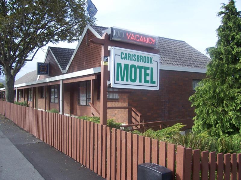a sign for a motel in front of a house at Carisbrook Motel in Dunedin